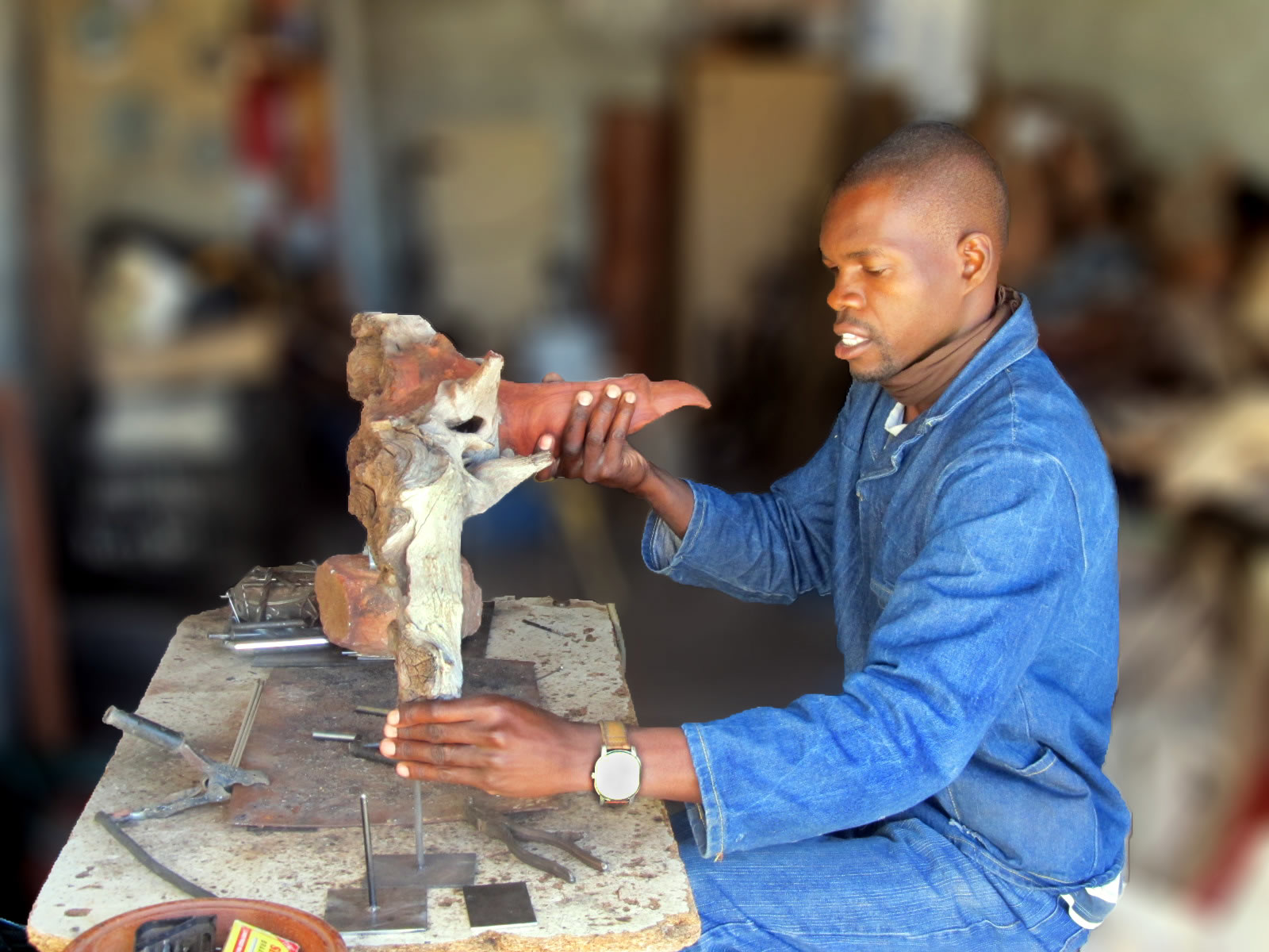 Boniface Chikwinhere creating wooden sculpture