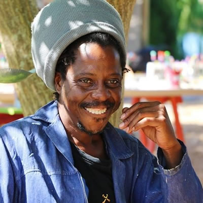 Tafara Karidza with his 3D township paintings on board and wire pictures